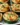 Ranch Cheddar Chicken Burgers on a grill with fresh toppings and herbs