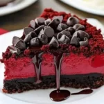 Slice of rich Red Velvet Cheesecake topped with cream cheese frosting
