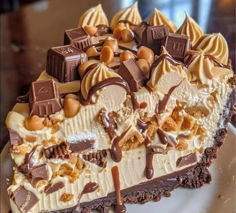 Delicious Reese's Peanut Butter Cup Cheesecake topped with chocolate and peanut butter