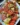 A vibrant Tomato and Artichoke Salad with Capers garnished with fresh herbs.