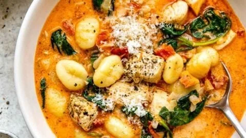 Bowl of rich, creamy Marry Me Chicken Soup garnished with herbs.