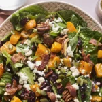 Roasted butternut squash salad with vibrant vegetables and dressing
