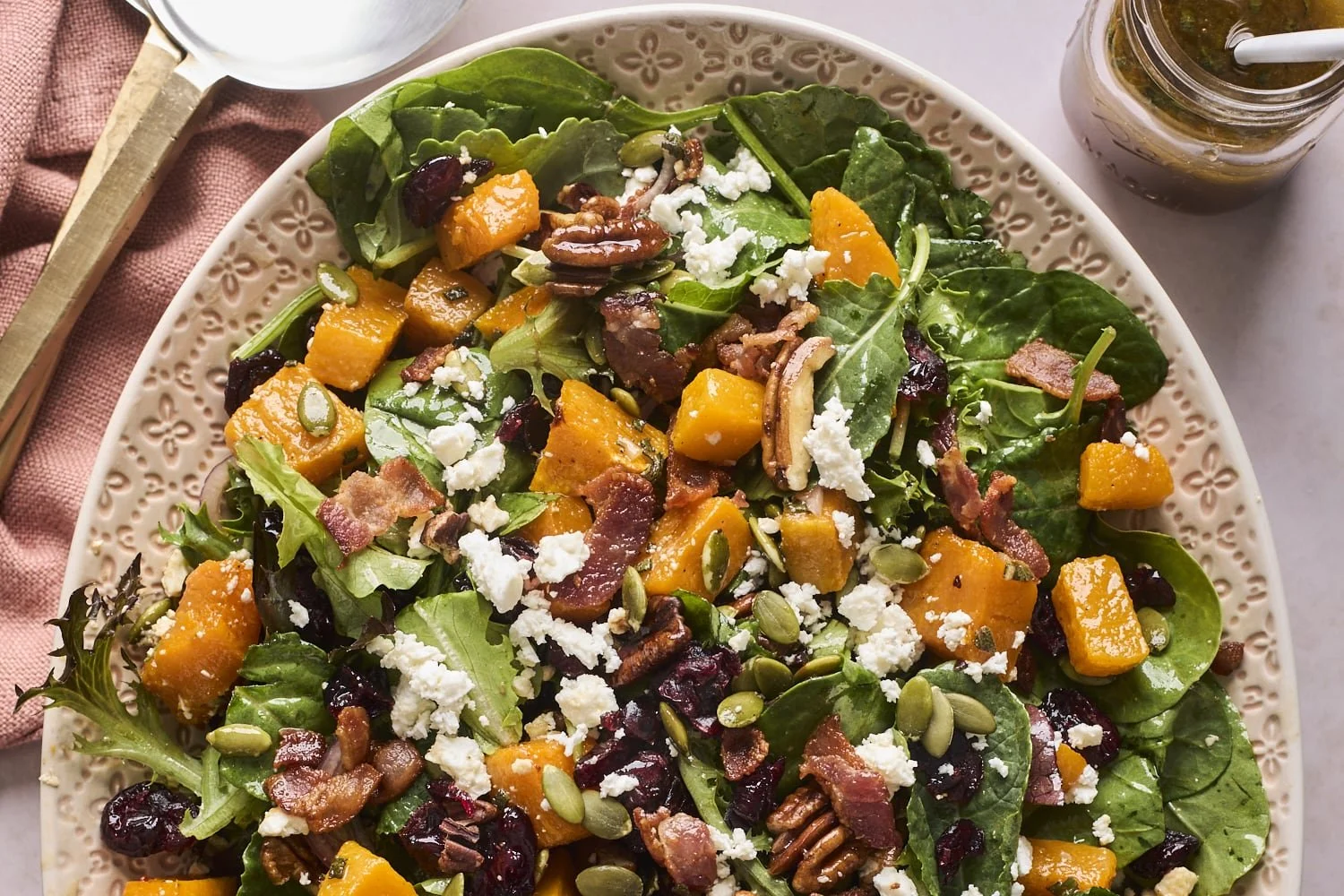 Roasted butternut squash salad with vibrant vegetables and dressing