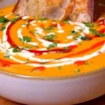 Bowl of homemade roasted butternut squash soup garnished with herbs