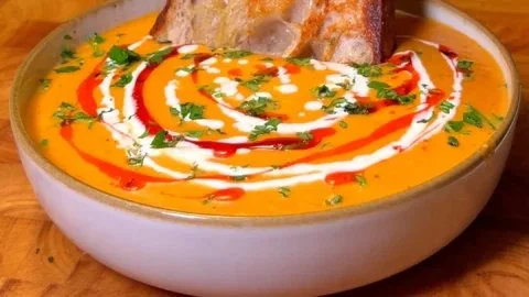 Bowl of homemade roasted butternut squash soup garnished with herbs