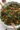 Roasted sweet potato kale salad drizzled with dressing and topped with nuts.