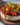 Savory cheesecake topped with roasted tomato jam and Parmesan crust on a plate