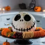 Skellington cheese ball appetizer on a serving platter decorated for Halloween