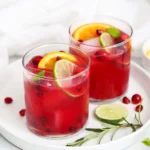 Sparkling citrus pomegranate mocktail in a glass with mint garnish