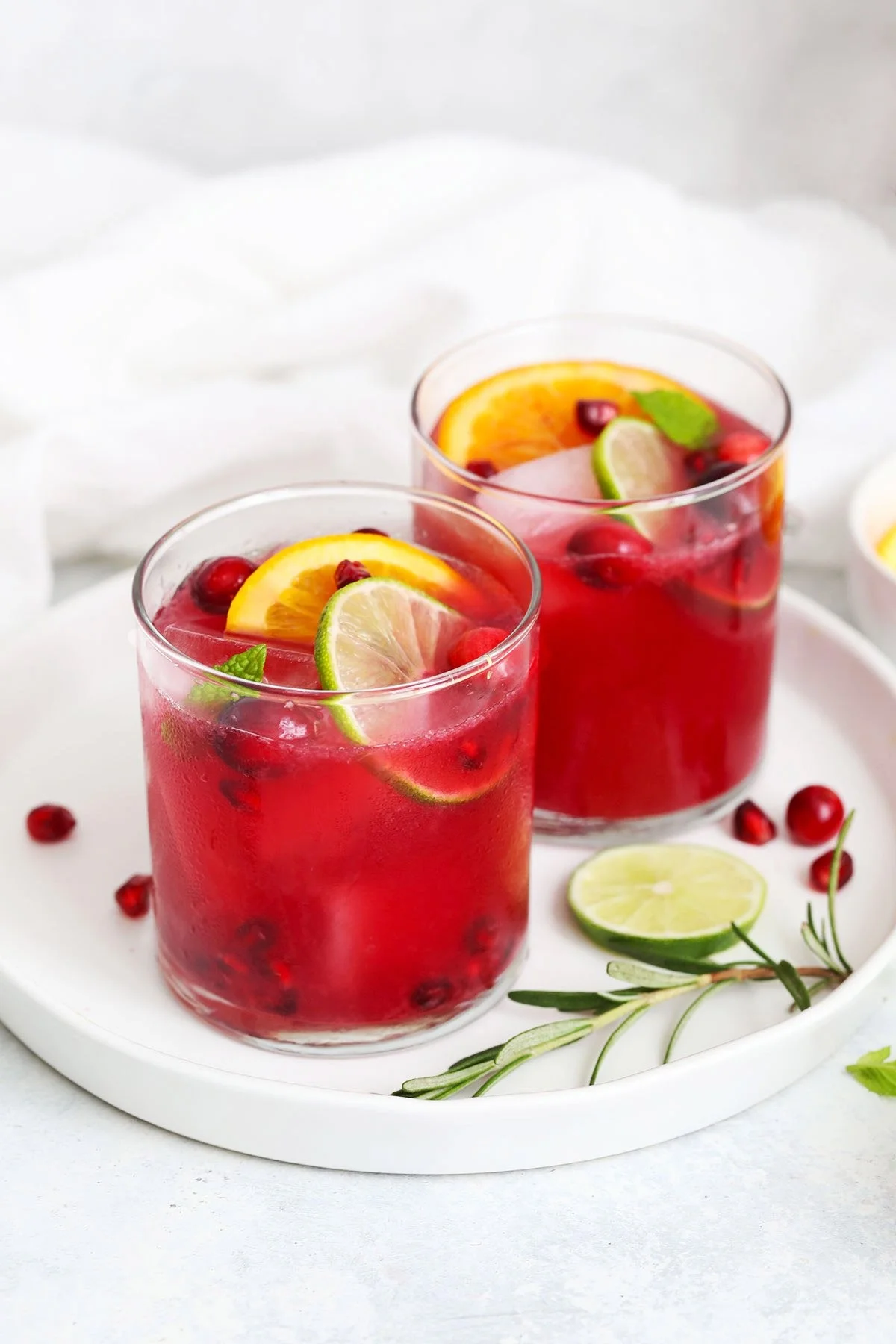 Sparkling citrus pomegranate mocktail in a glass with mint garnish