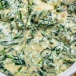 Delicious homemade spinach dip served in a bowl with fresh vegetables