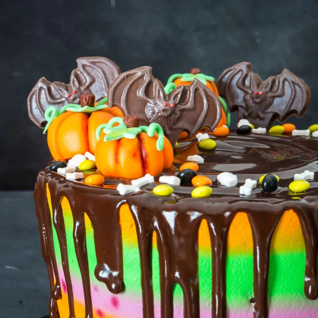 Spooky Halloween cake decorated with ghosts and pumpkins for festive celebrations.