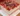 Delicious strawberry cream two-layer square cake with fresh strawberries on top.