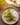 Bowl of summer coconut chickpea curry served with rice on a wooden table