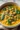 Bowl of Turmeric Chickpea Soup garnished with fresh herbs