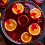 Glass of Vampire Punch for Halloween with red and black garnishes.