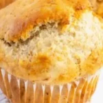 Vegan banana muffins baked golden brown with fresh bananas and nuts on a plate