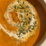 Vegan roasted butternut squash soup with carrots and coconut in a bowl