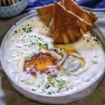 Creamy whipped feta with a drizzle of hot honey served in a bowl.