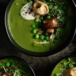 Bowl of delicious green pea soup known as Witches Brew, garnished with fresh herbs.
