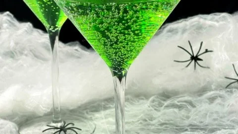 Bowl of colorful Witches Brew Punch with spooky decorations