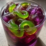 Witch’s Potion Punch in a cauldron with spooky decorations for Halloween.