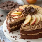 Apple Chocolate Harmony Cake topped with fresh apples and chocolate drizzle.