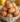 Delicious homemade apple fritter bites topped with glaze on a plate.