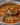 Bowl of delicious barley soup with vegetables and herbs