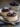 Blackberry and violet panna cotta garnished with almond tuile on a plate