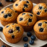 Freshly baked blueberry muffins garnished with blueberries