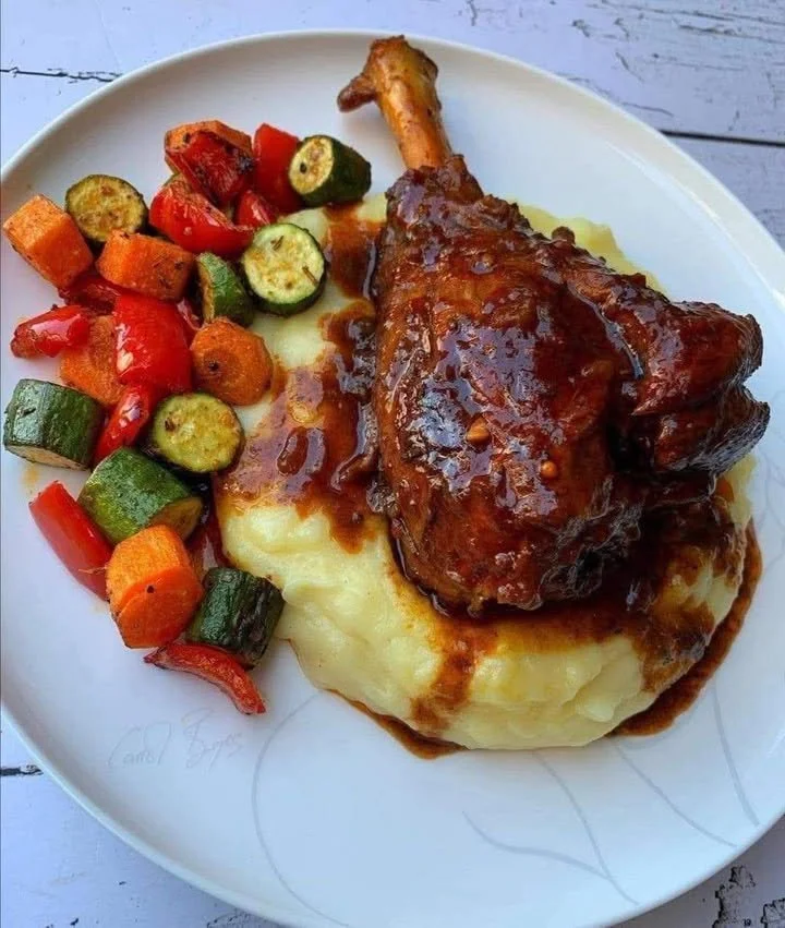Delicious braised lamb shank served with creamy mashed potatoes and roasted vegetables