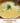 Bowl of creamy Broccoli Cheddar Soup garnished with fresh herbs