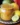 Bottle of Caribbean Lime Lemon Pepper Sauce with fresh limes and lemons.