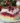 Delicious Christmas Cranberry Poke Cake topped with whipped cream and cranberries