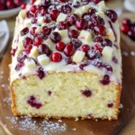 Delicious Christmas Cranberry Pound Cake topped with festive cranberries and icing.