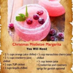 Large batch Christmas mistletoe margarita ready for serving in festive glasses