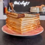 Cyril Lignac preparing crêpes in a modern kitchen