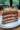 Delicious slice of decadent chocolate peanut butter cake with creamy frosting.