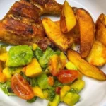Grilled chicken quarters with crispy wedges and tropical avocado-mango salad