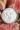 Homemade horseradish sauce in a glass jar with fresh horseradish roots.