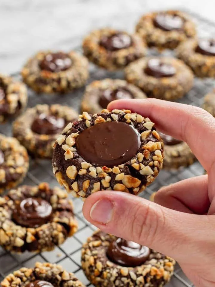 Baked chocolate hazelnut cookies on a cooling rack, showcasing their rich texture.