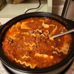A bowl of delicious lasagna soup topped with fresh basil and cheese.