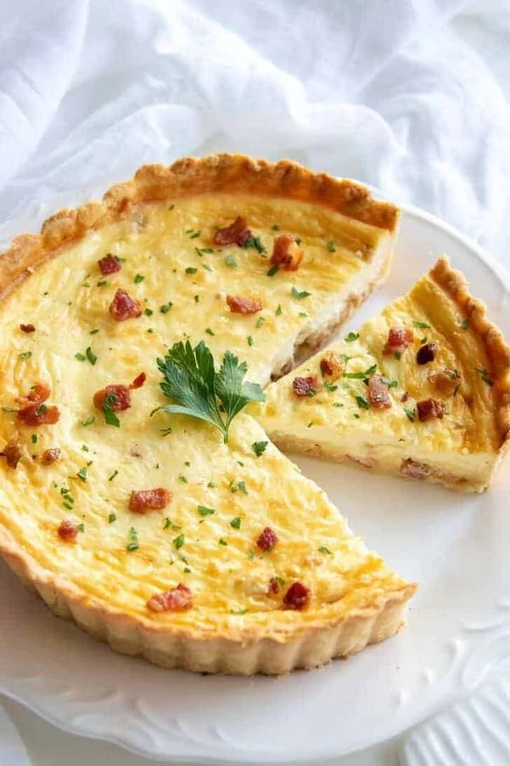 Delicious Lorraine quiche with cheese and bacon served on a plate
