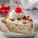 Delicious slice of Million-Dollar Pie with a creamy topping and graham cracker crust.