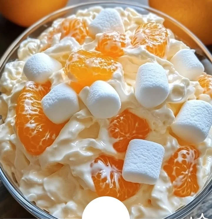 Orange Dreamsicle Salad with vibrant oranges and creamy dressing on a plate.