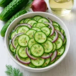 Delicious pickled cucumber salad garnished with fresh herbs