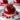 Pomegranate Mousse glossy mousse domes on a white plate, garnished with pomegranate seeds.