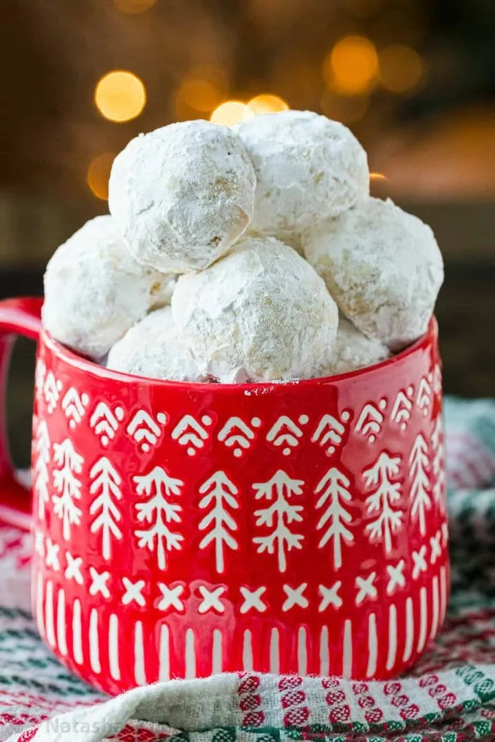 Plate of delicious Russian Tea Cakes dusted with powdered sugar.