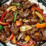 Sizzling Chinese pepper steak with onions served on a plate